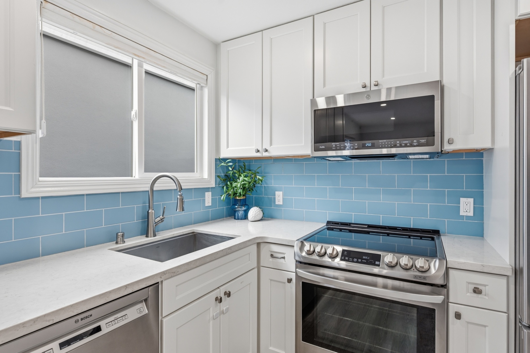 Remodeled kitchen with blue subway tile